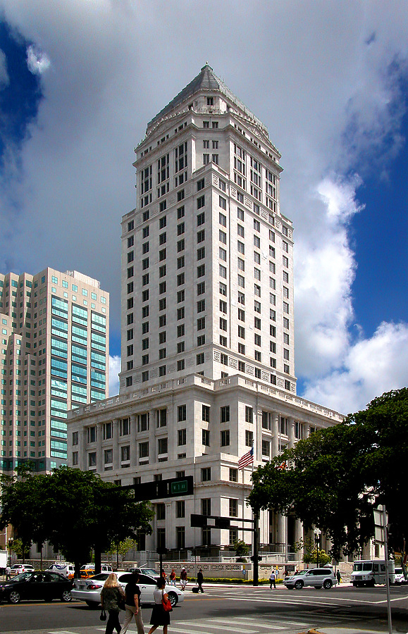 Miami-Dade County Courthouse, a tall white building with a decorative top and columns at the base.